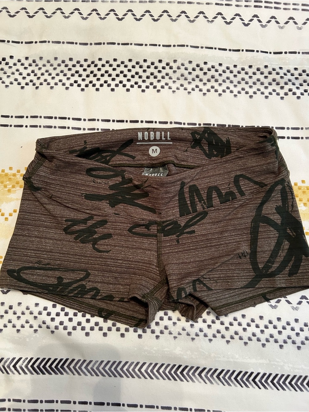 NOBULL Brown Script Bike Shorts with Black Print